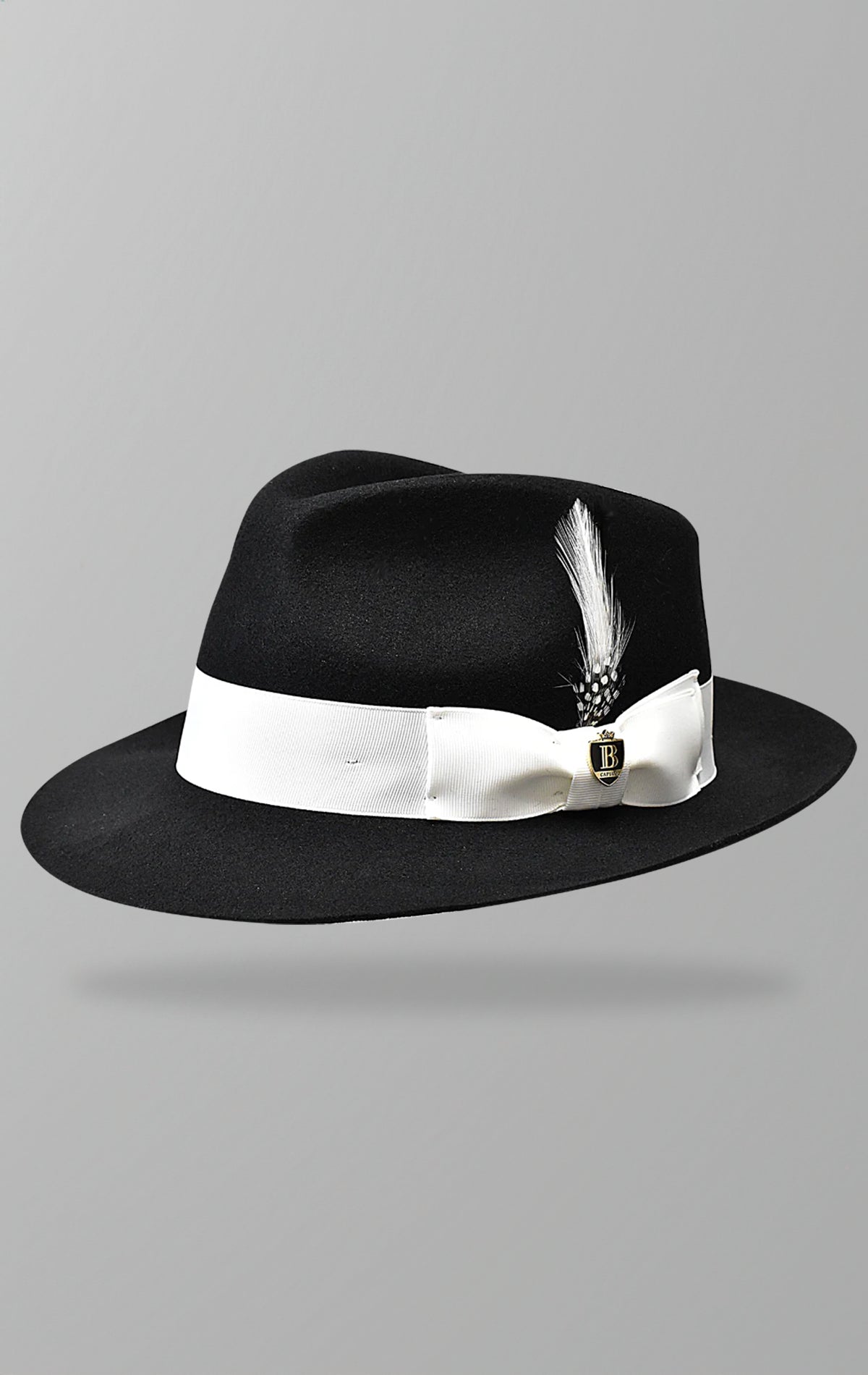 2.5-inch raw edge fedora made from 100% fine Australian wool with a tear drop crown, grosgrain band, and removable Bruno logo pin.