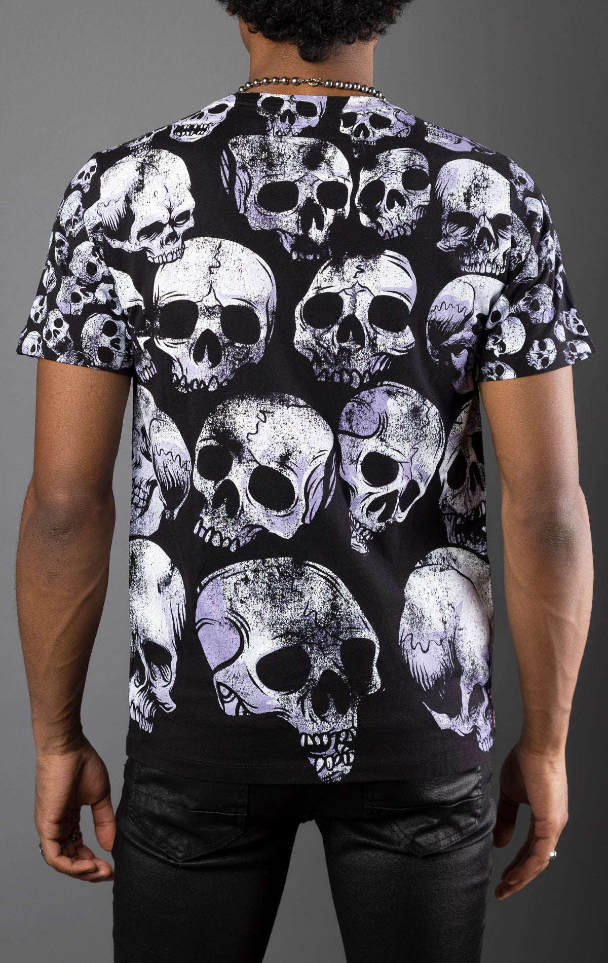 Black cotton tee with distressed all-over repeat skull print