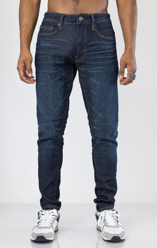 Men's Sean Slim Taper jeans in dark indigo. The jeans feature a regular rise waist, a comfortable fit from waist to thigh, a slim taper from knee to ankle, 3D baked wrinkles for texture, a raw denim look, and are made from a super stretch fabric blend (35% Cotton, 30% Polyester, 34% Tencel and 1% Elastane).
