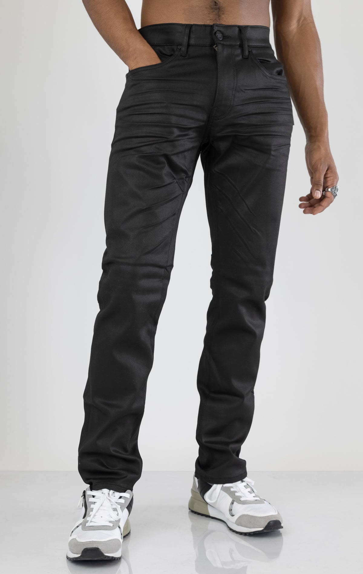 Men's black denim pants with a glossy coated finish. The pants feature a regular rise, straight leg fit, 3D hand-formed wrinkles for texture, and are made from a super stretch fabric blend (67% Modal, 29% Polyester and 4% Elastane).