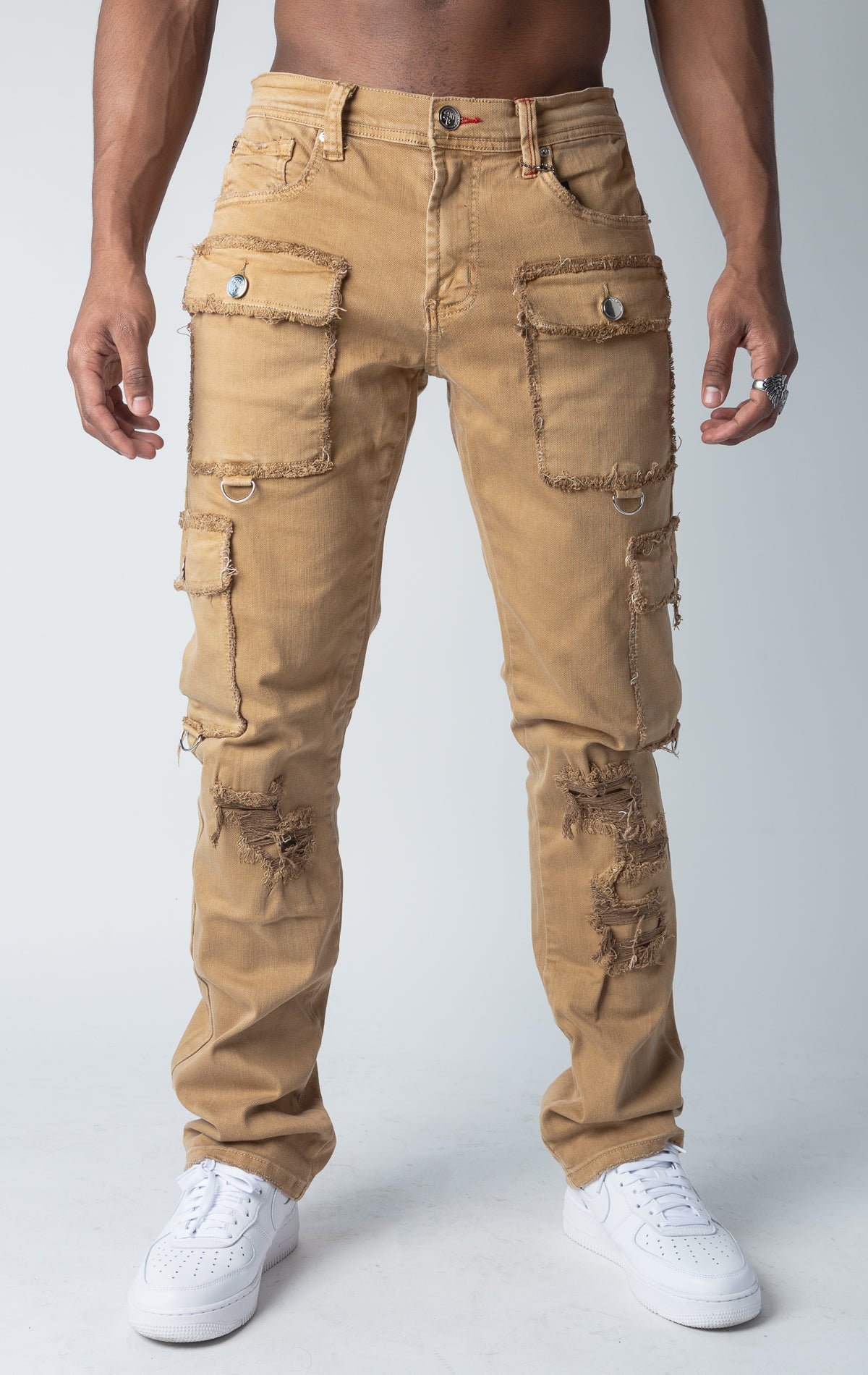 Slim fit, stretch denim cargo jeans with multiple pockets, distressed detailing at the edges, and reinforced stitching.