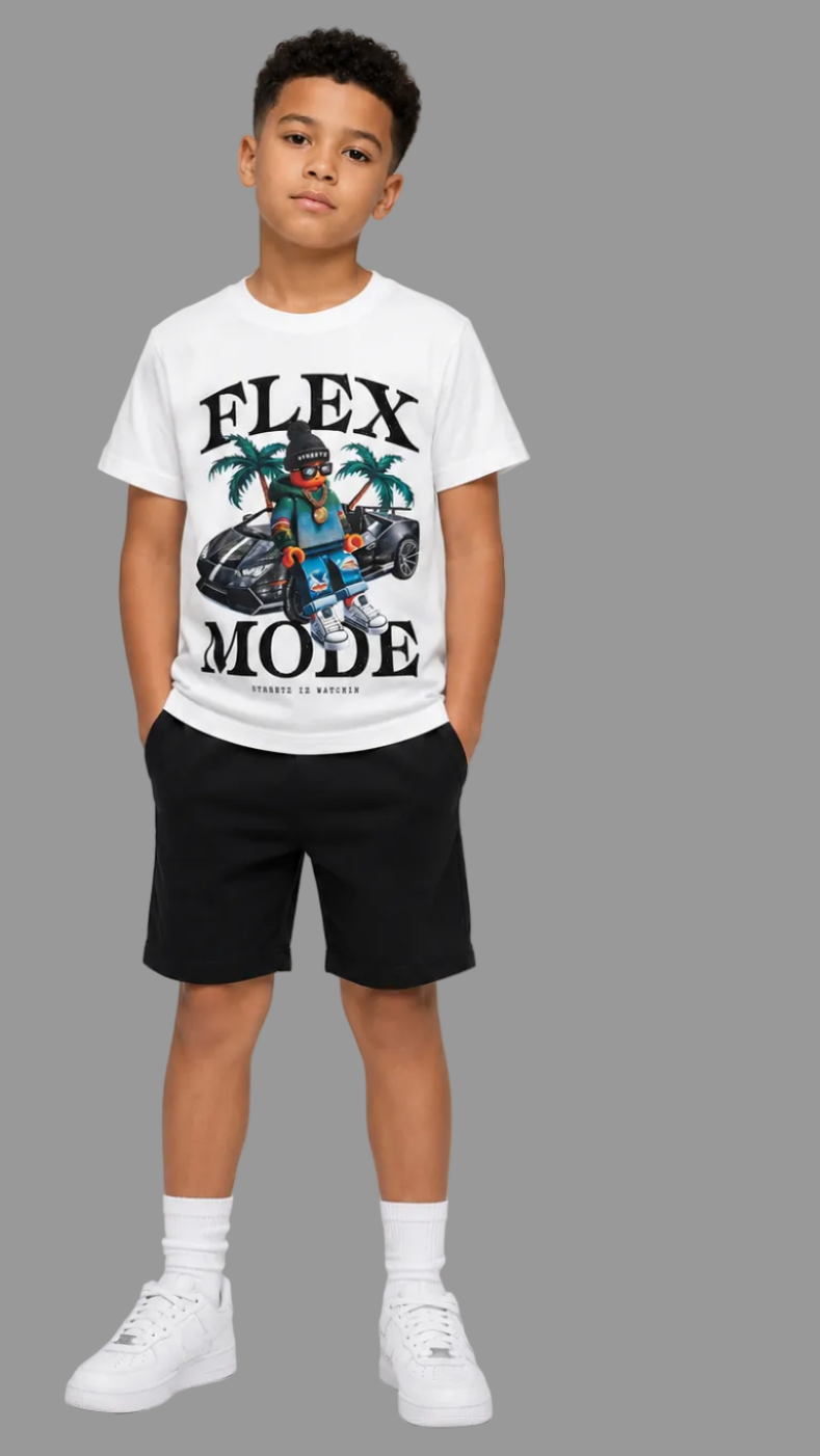 A child model shown from the front wearing a white short-sleeve graphic T-shirt with black shorts, white socks, and white sneakers against a light gray studio background.