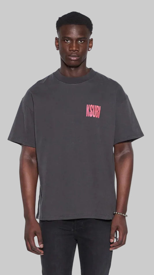 Man wearing a dark gray t-shirt with a red "Ksubi" logo on a grey background