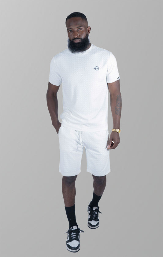White Modena Knit Tee. Made from a high-quality blend of 95% cotton and 5% spandex for a soft and comfortable feel. Features a unique embossed jacquard fabric with colored blocking for a textured and stylish look. This tee is pre-shrunk and true to size.