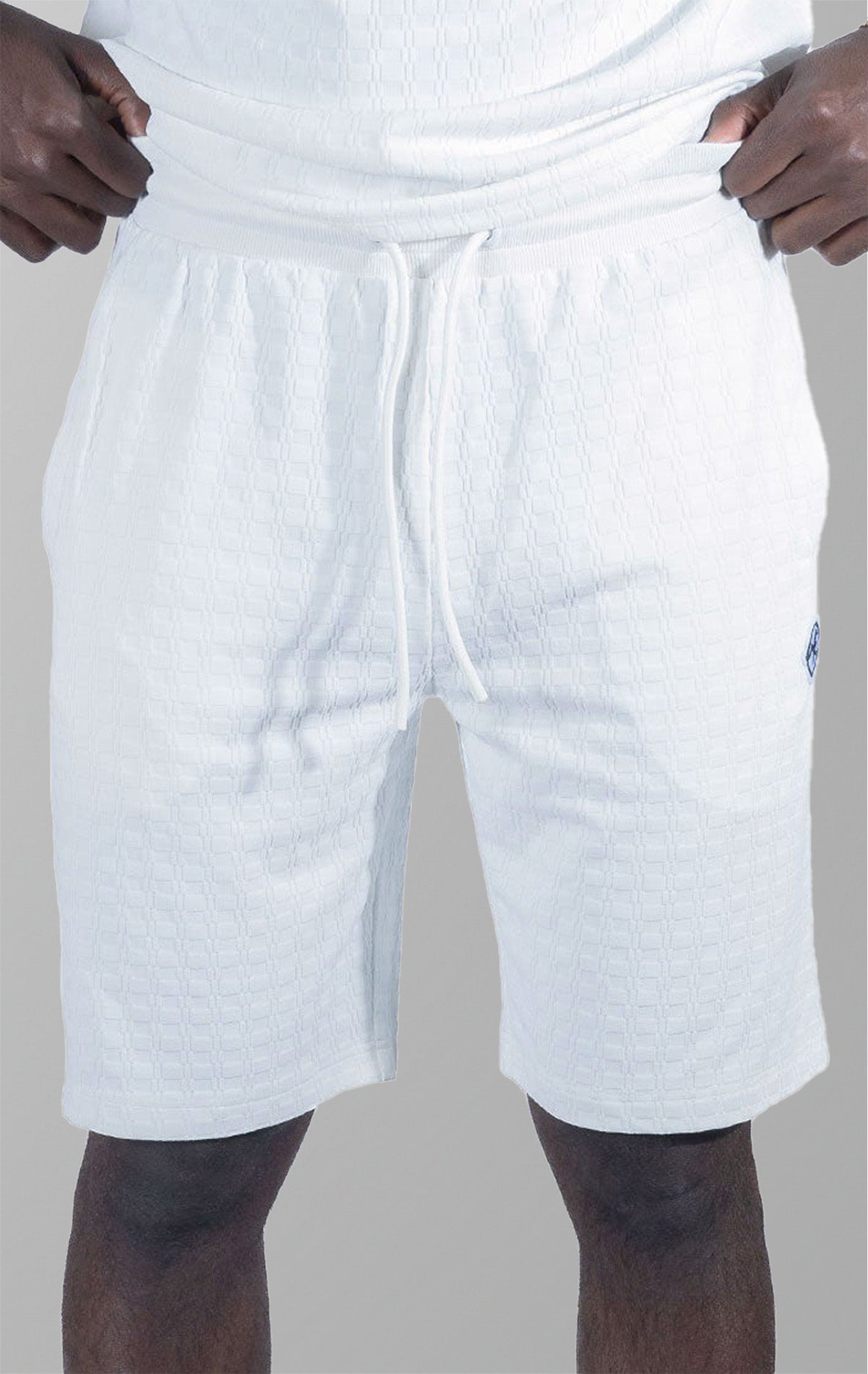 Modena Knit Shorts in white. Made from a high-quality blend of 95% cotton and 5% spandex for a soft and comfortable feel. Features a unique colored blocking design and a pre-shrunk true-to-size fit.