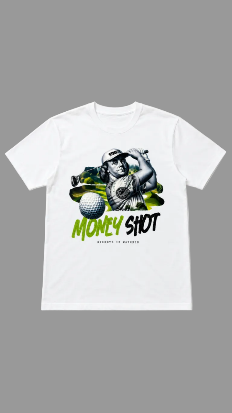 A white short-sleeve crewneck t-shirt featuring a graphic print of a golfer swinging a club, a golf ball, and the text 'MONEY SHOT' in green and black, with 'STREETZ IZ WATCHIN' printed below.