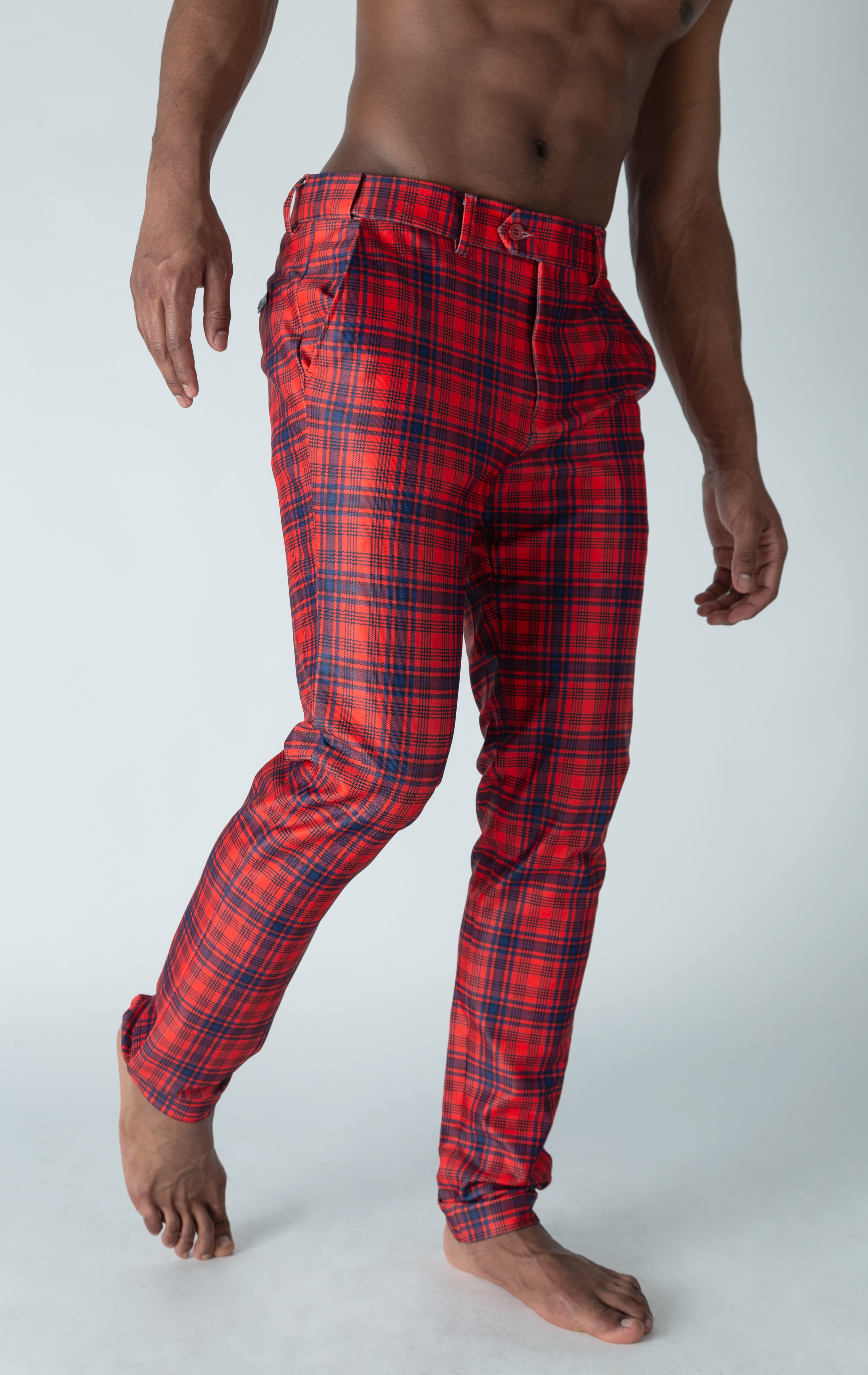 Men's red chino pants with a checkered plaid design. The pants feature an elastic waistband for comfort and stretch, and are made from a lightweight cotton-spandex blend fabric. Inseam is 32 inches. 