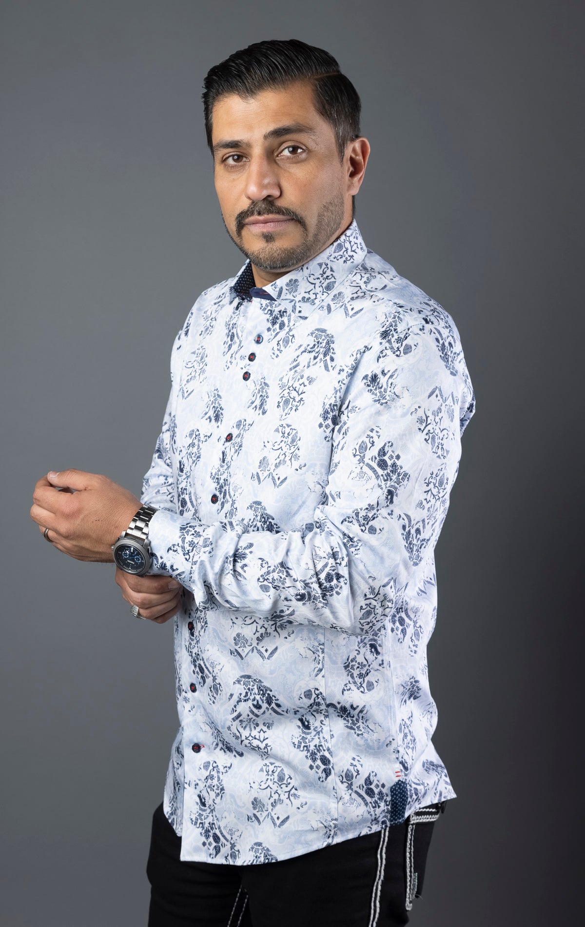 Men's casual dress shirt with 98% cotton and 2% spandex for optimum comfort, featuring contrasting patterns, sophisticated details, and Au Noir signature elements, including angled buttonhole, grouped buttons, embroidery detailing, and elegant ceramic button on the sleeve placket. Canadian owned and designed, machine washable, and modern-fit.