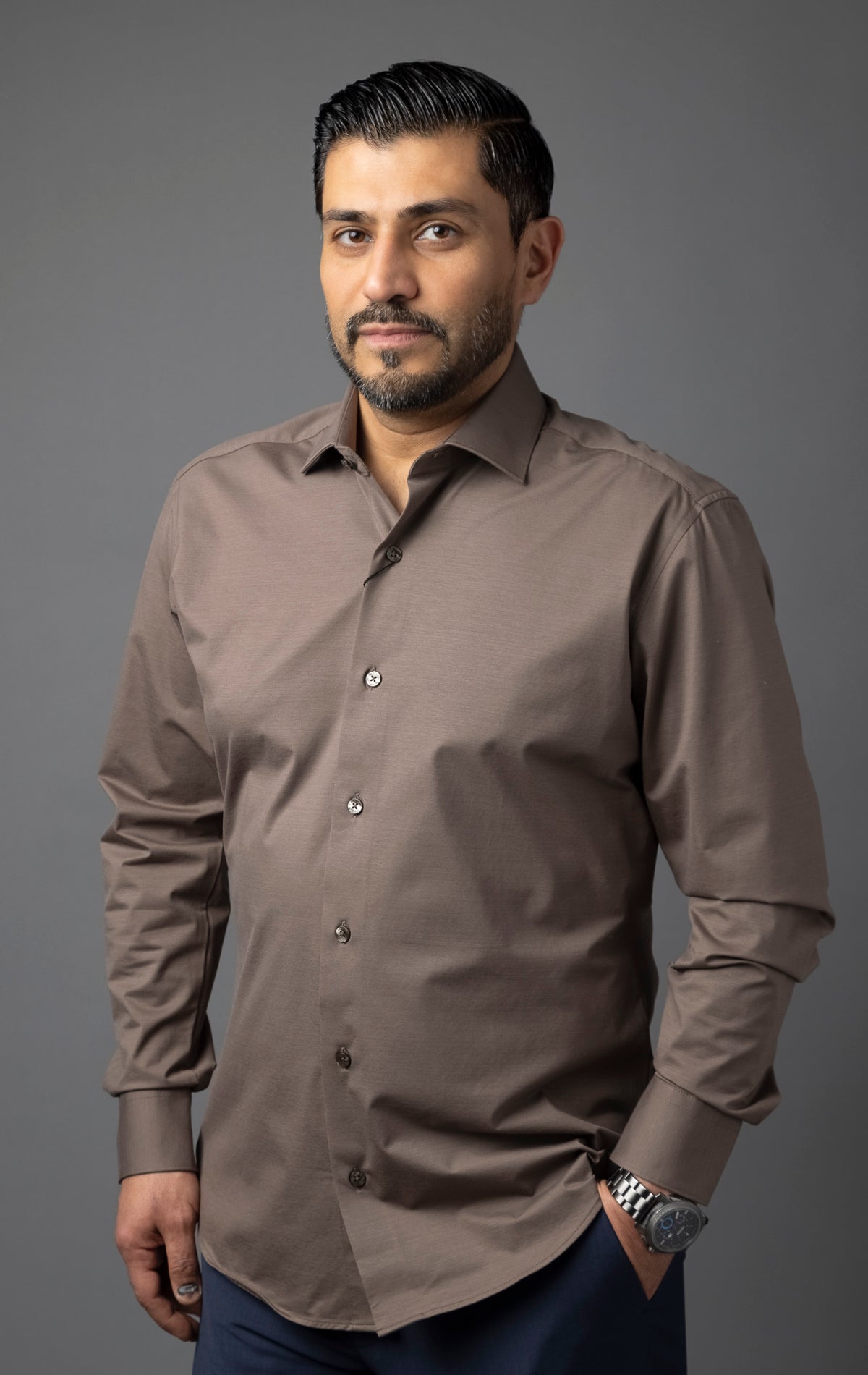 Men's long-sleeve formal shirt in a brown color. The shirt has a regular fit, point collar, and button fastening down the front.