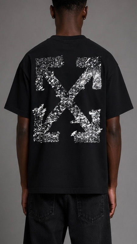 Person wearing a black t-shirt with a white graphic design on the back against a gray background