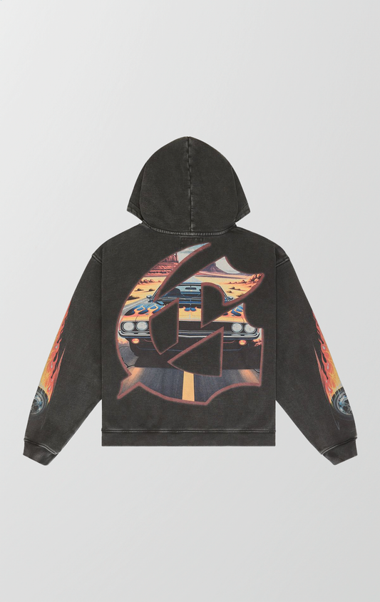 Vintage black wash Godspeed hoodie featuring a POV graphic of a cracked windshield, red fuzzy dice, and a muscle car on a desert highway. Sleeves feature flame and tire designs, and the back has a large G logo with desert scenery fill.