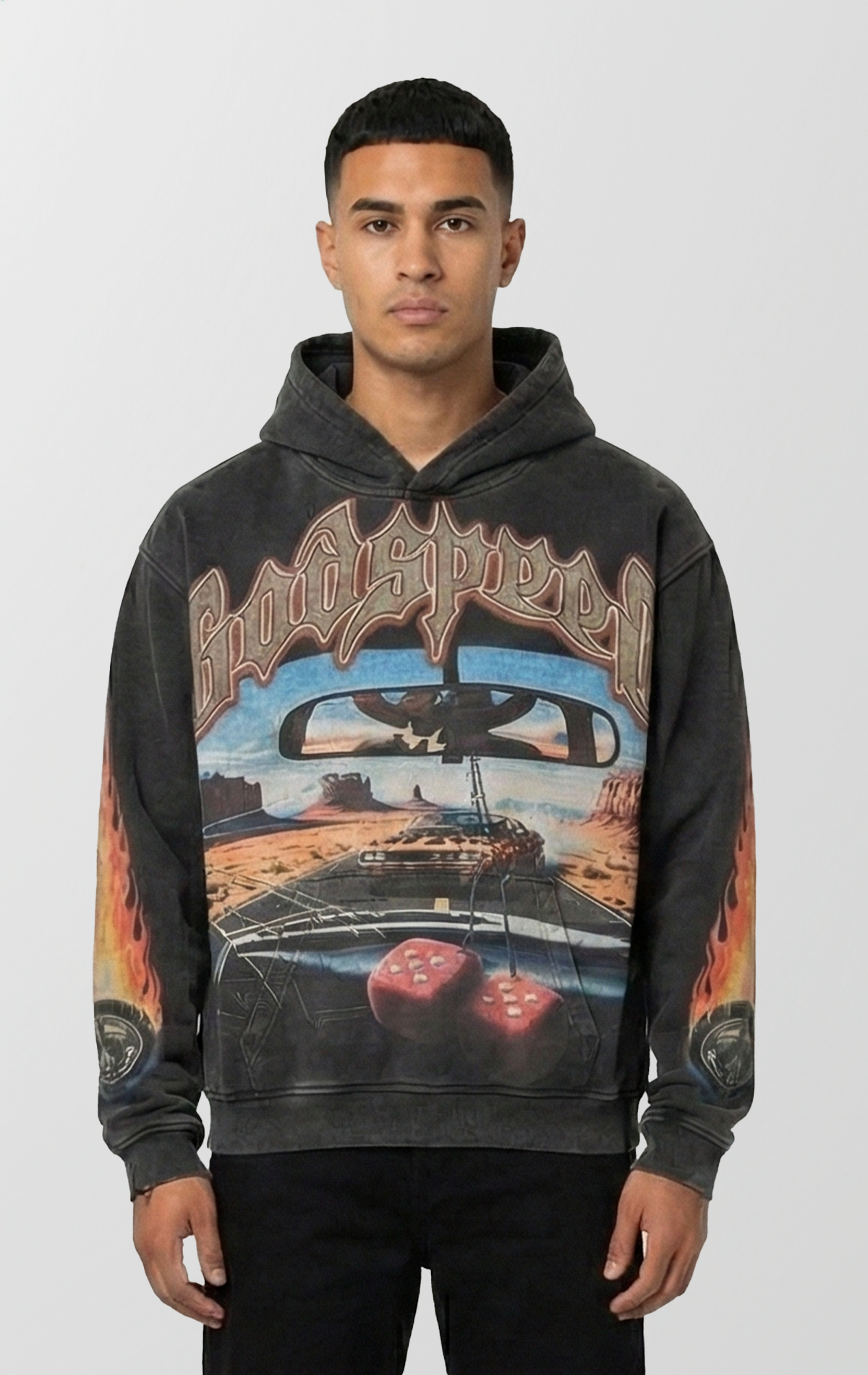 Vintage black wash Godspeed hoodie featuring a POV graphic of a cracked windshield, red fuzzy dice, and a muscle car on a desert highway. Sleeves feature flame and tire designs, and the back has a large G logo with desert scenery fill.