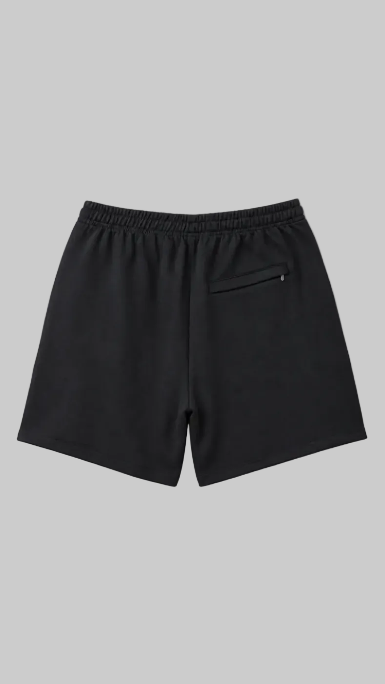 Black athletic shorts with an elastic waistband and a side zip pocket, shown from the back on a light gray background.
