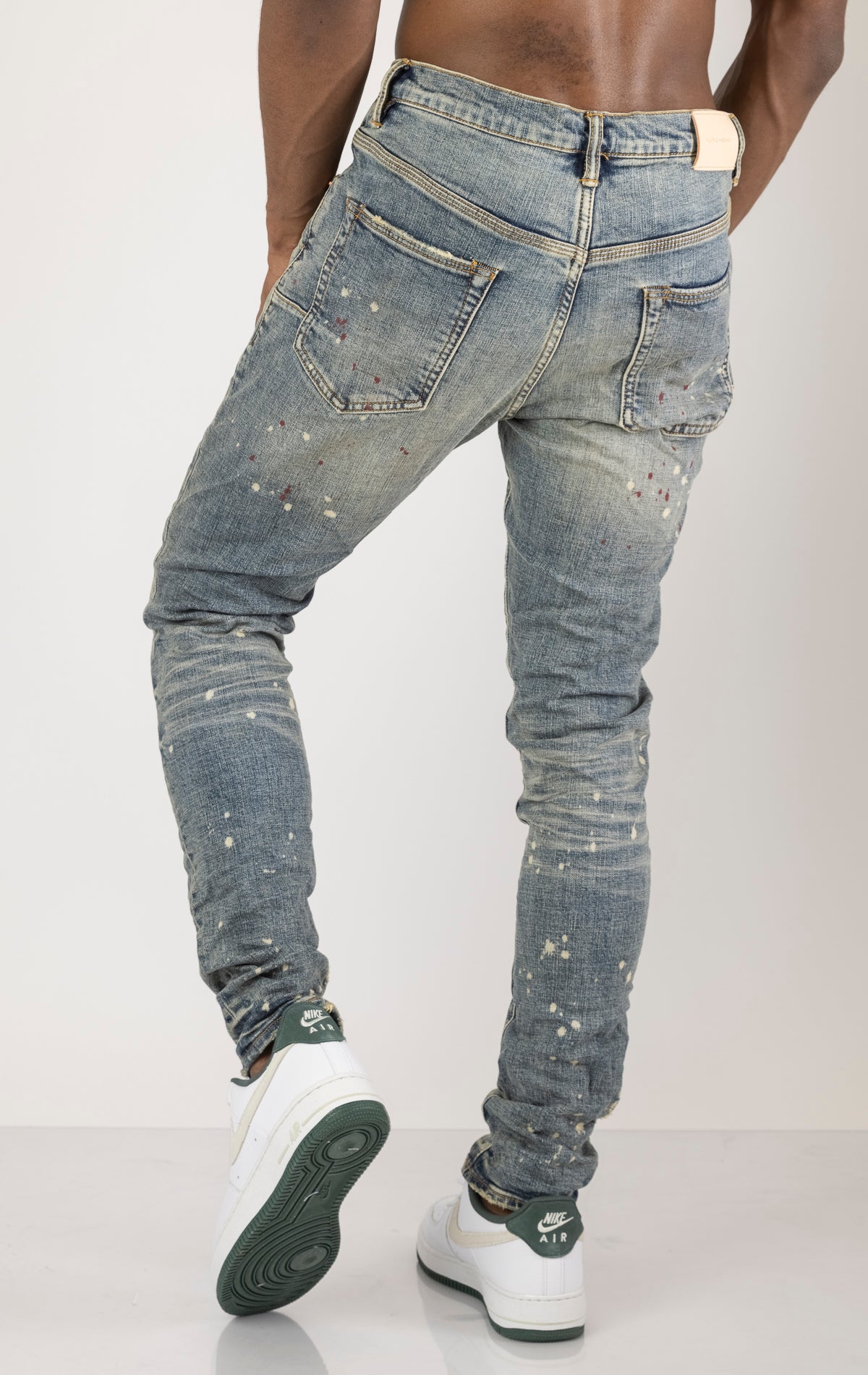 Vintage Spotted Indigo Jeans in dark wash with subtle lighter colored spots. Made from 98% cotton and 2% elastane for comfort. Features include lined back pockets and yoke for comfort and shape retention, reinforced belt loops, and hidden back pocket rivets.