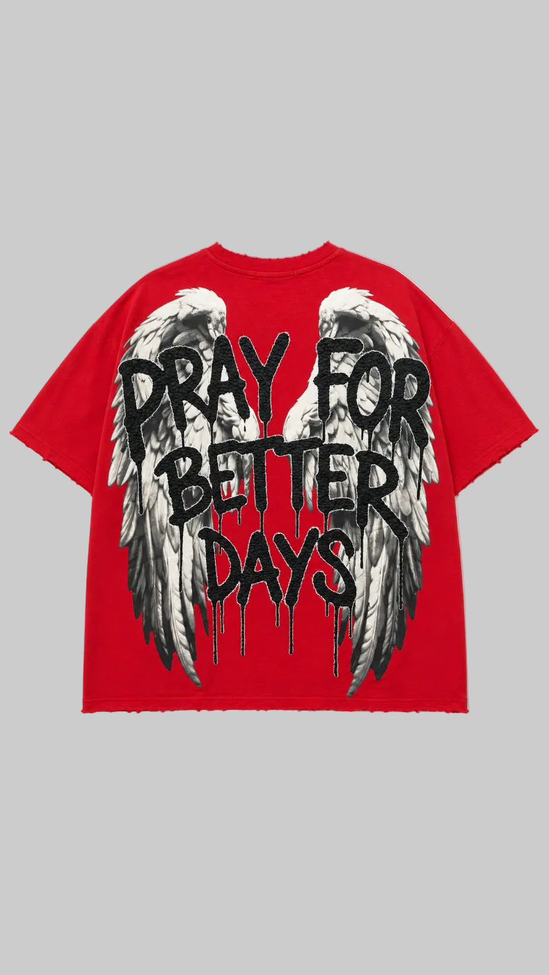 A red short-sleeve t-shirt with a large graphic print on the back featuring white and black angel wings and the text 'PRAY FOR BETTER DAYS' in a black dripping font.