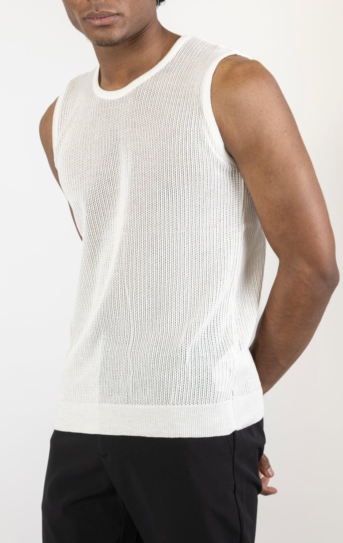 Men's crew neck mesh tank top in white. The tank top is made from a lightweight and breathable mesh fabric (50% cotton, 50% acrylic) and features a sleeveless construction and a tailored fit.
