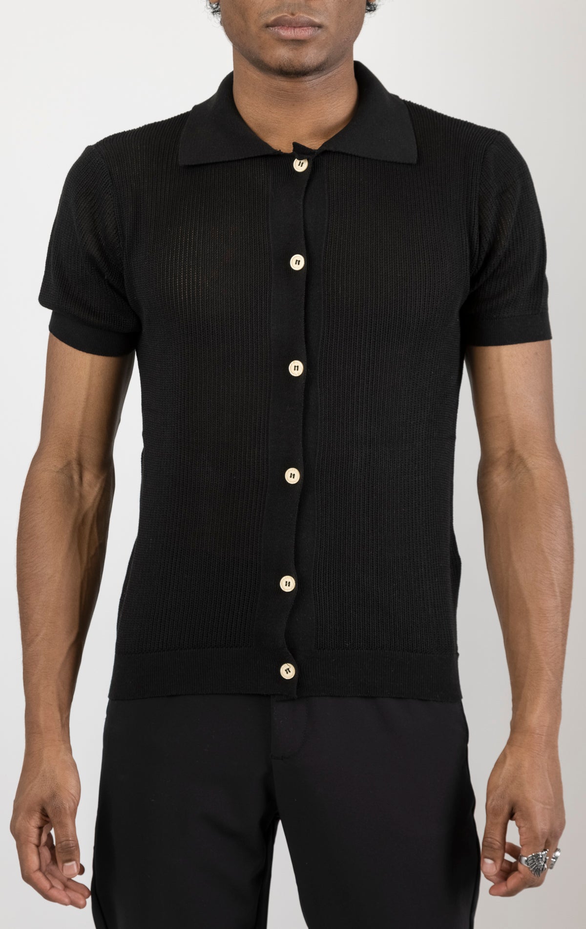 Men's see-through button-down mesh top in black. The top is made from a 50% cotton, 50% acrylic blend and features a tailored fit with a sheer mesh fabric and button-down closure.