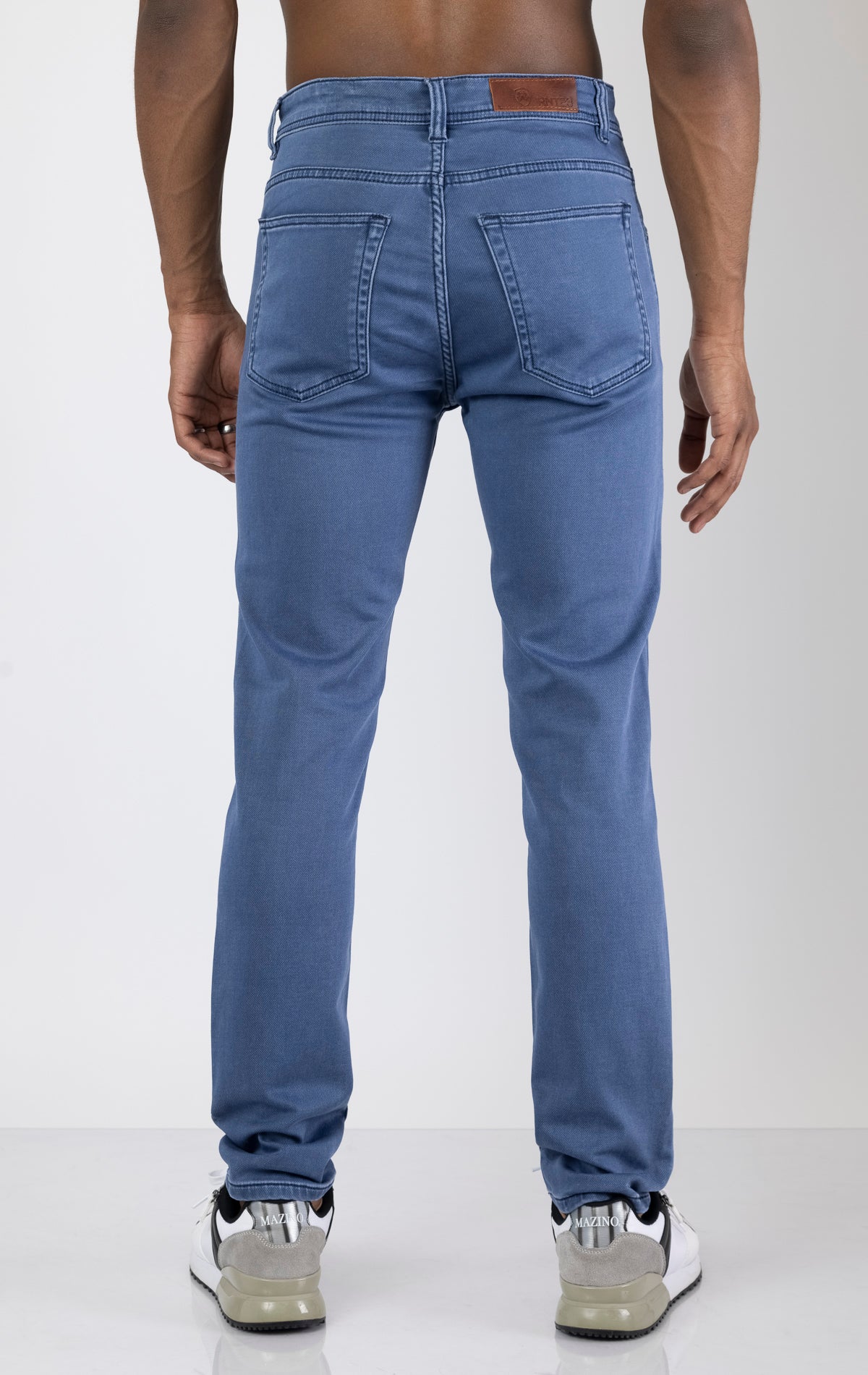 Men's super soft 5-pocket style pants in indigo color. The pants are made from a 98% cotton, 2% elastane blend and feature a tailored fit with a hint of stretch, classic 5-pocket styling (two front pockets, two back pockets, and a coin pocket).
