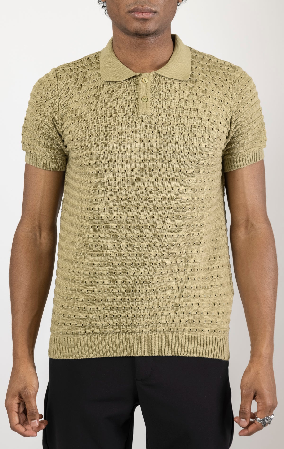 Men's eyelet short sleeve polo tee in light green. The shirt is made from a soft and breathable fabric (50% viscose, 50% polyamide) and features a classic polo collar, short sleeves, and delicate eyelet detailing along the sleeves.