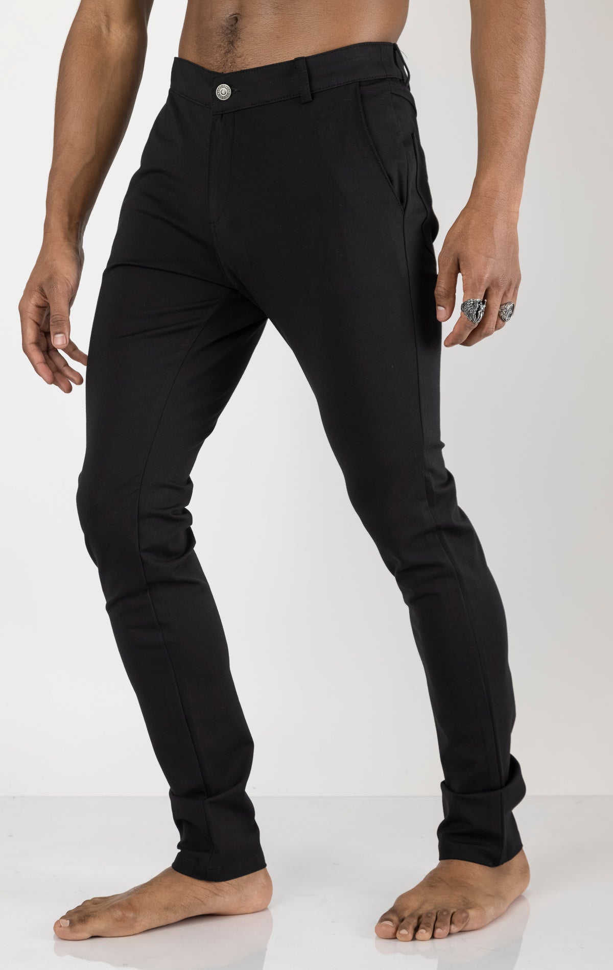 Men's casual wear pants in black. The pants are made from a blend of rayon (65%), nylon (27%), and elastane (8%) and feature a classic design with straight or tapered legs, belt loops, pockets, and a zip fly with button closure.