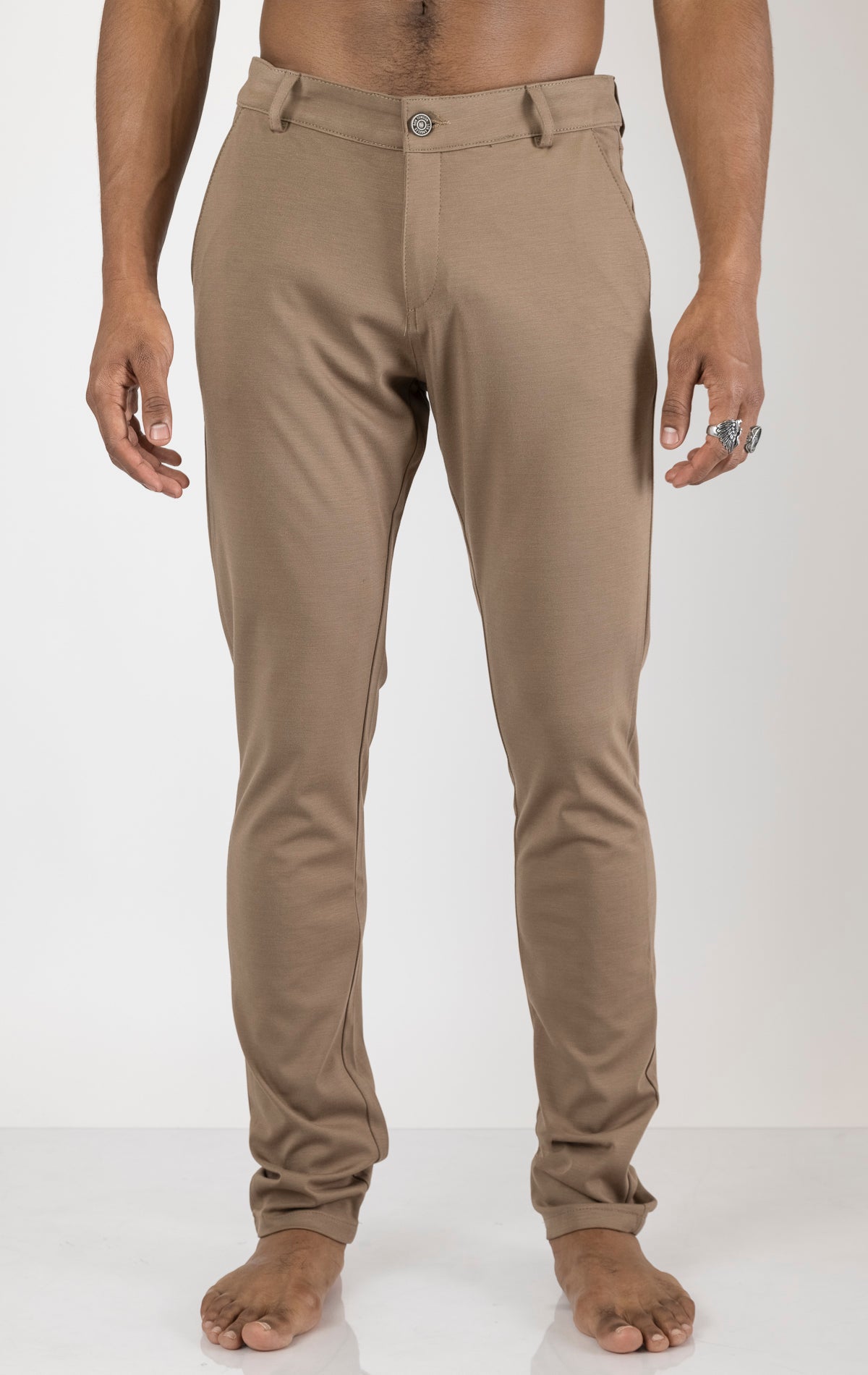 Men's casual wear pants in camel. The pants are made from a blend of rayon (65%), nylon (27%), and elastane (8%) and feature a classic design with straight or tapered legs, belt loops, pockets, and a zip fly with button closure.