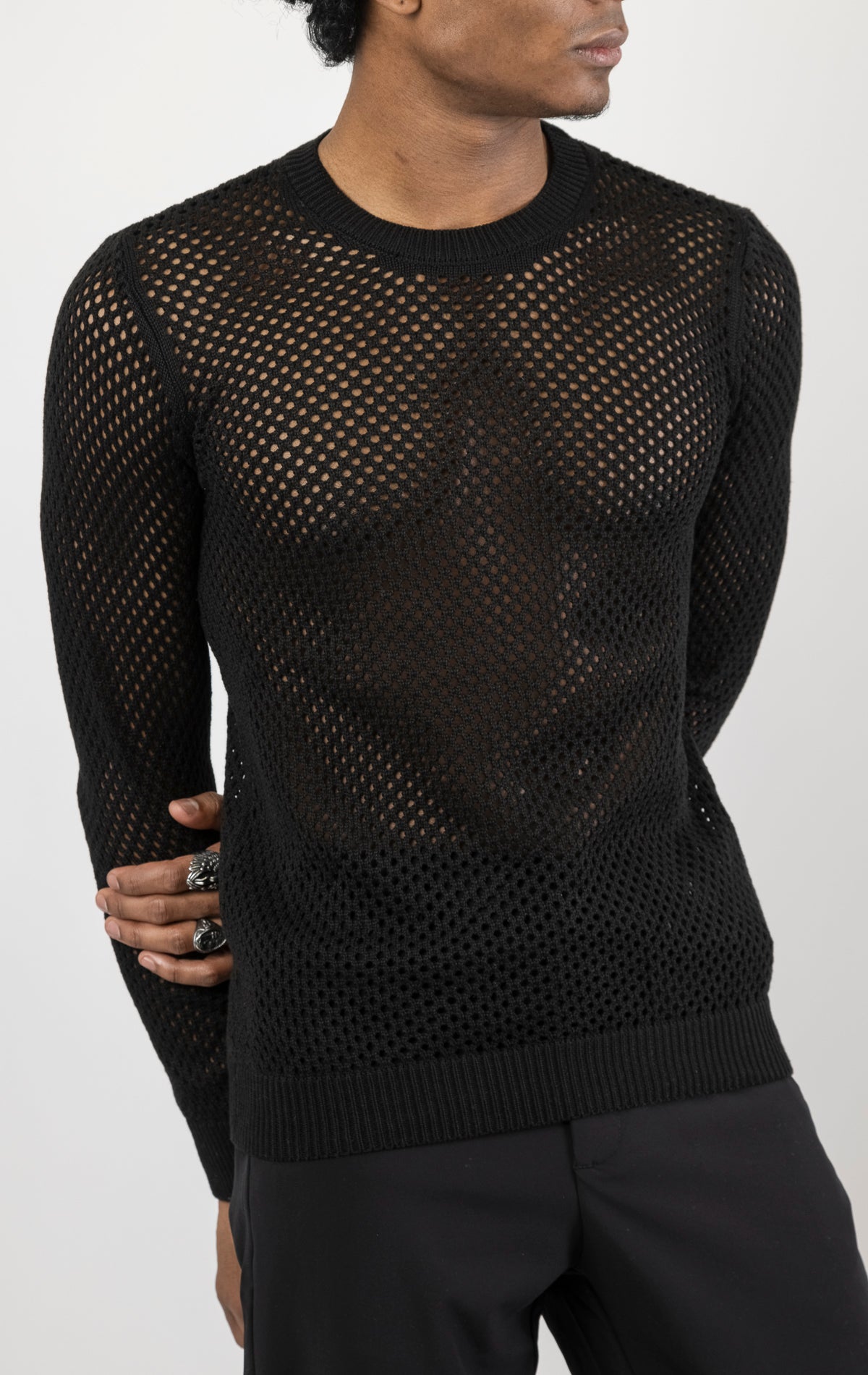 Men's see-through fishnet muscle fit shirt in black. The shirt is made from a 50% cotton, 50% acrylic blend and features a muscle fit silhouette with a see-through fishnet fabric design.