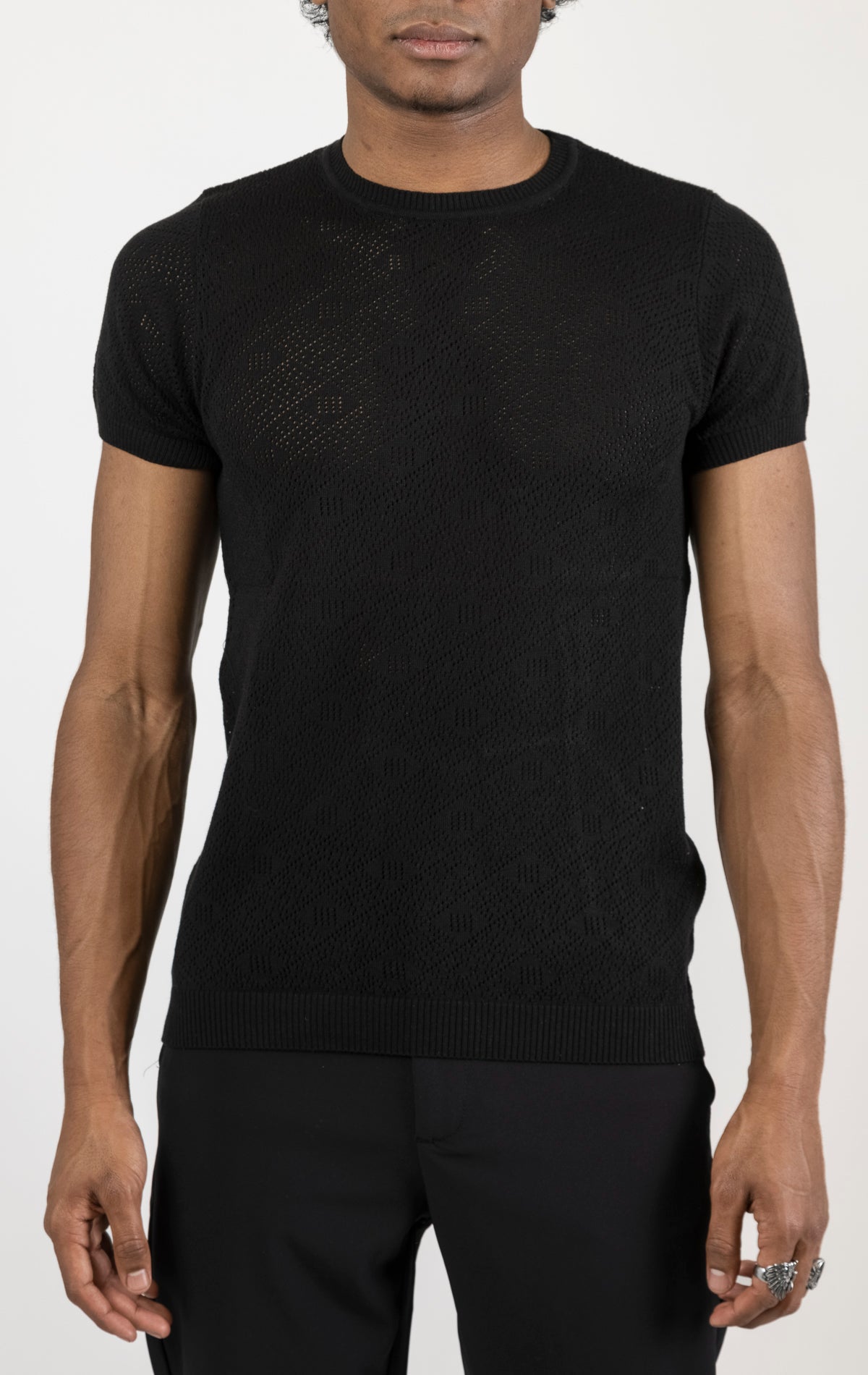 Women's geometric crochet knit top in black. The top is made from a 50% viscose, 50% polyamide blend and features a unique geometric crochet pattern.