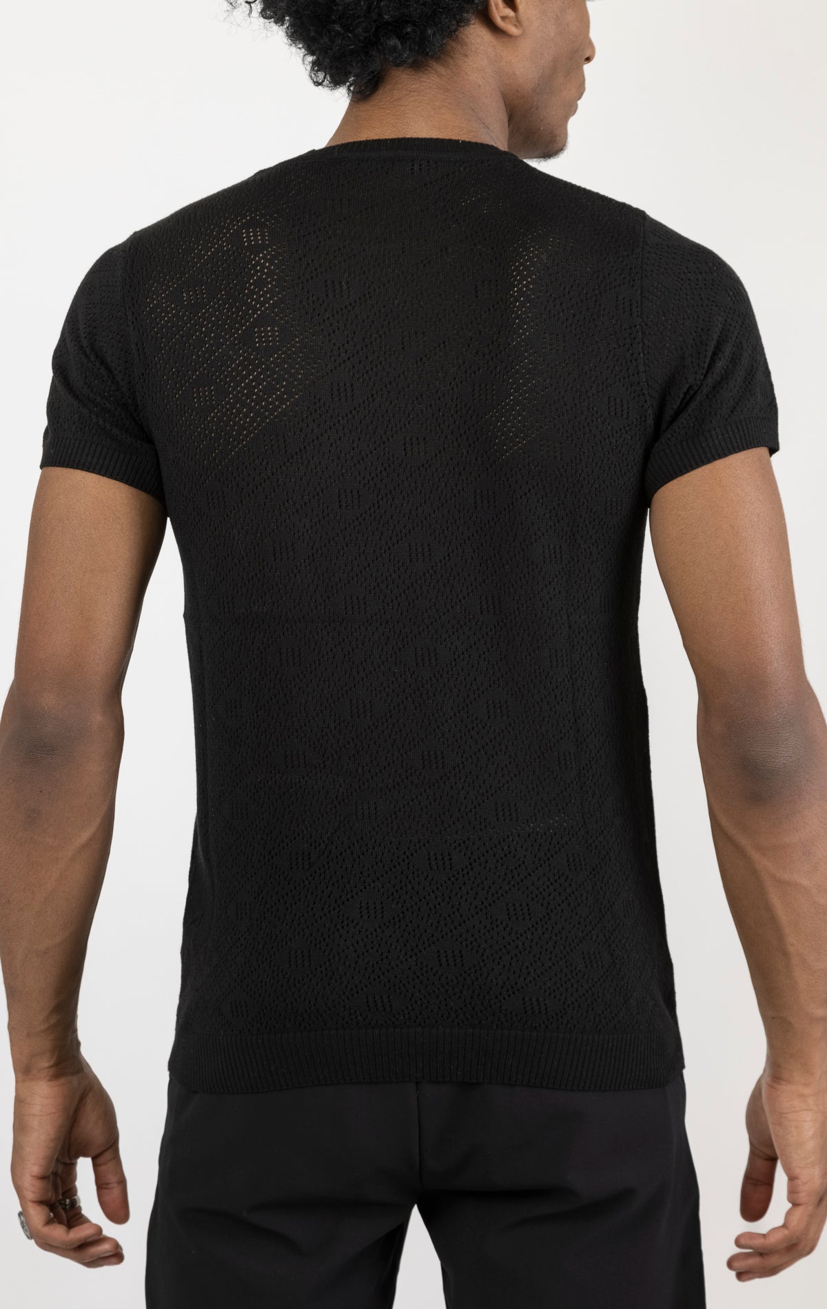Women's geometric crochet knit top in black. The top is made from a 50% viscose, 50% polyamide blend and features a unique geometric crochet pattern.