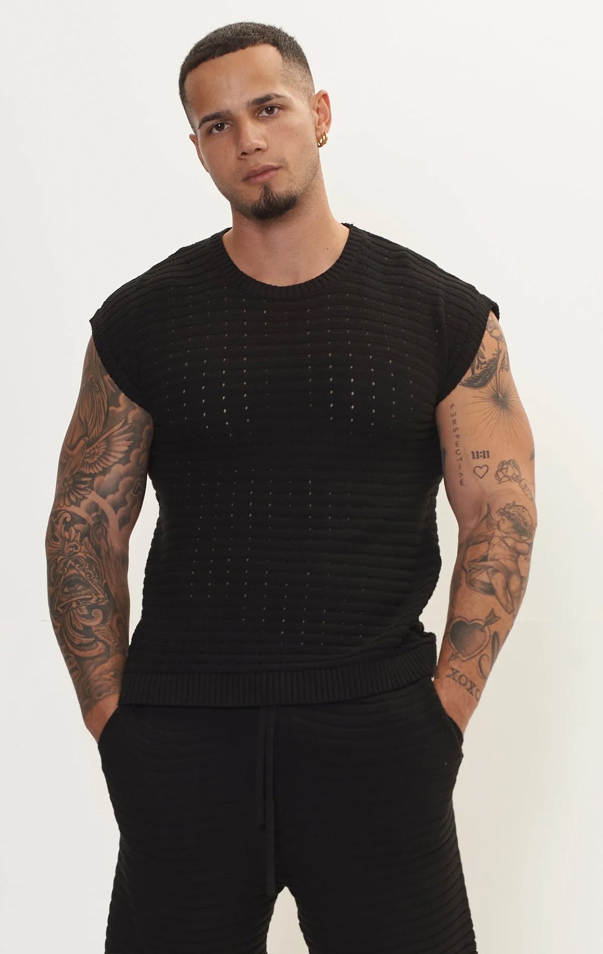 Men's black eyelet short sleeve knit top and shorts set in a variety of colors. The set is made from a soft and breathable knit fabric (50% viscose, 50% polyamide) and features a relaxed-fit top with eyelet detailing on the short sleeves and comfortable shorts with an elastic waistband.