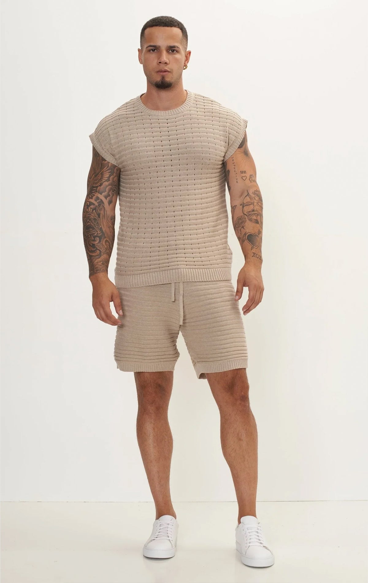 Men's stone eyelet short sleeve knit top and shorts set in a variety of colors. The set is made from a soft and breathable knit fabric (50% viscose, 50% polyamide) and features a relaxed-fit top with eyelet detailing on the short sleeves and comfortable shorts with an elastic waistband.