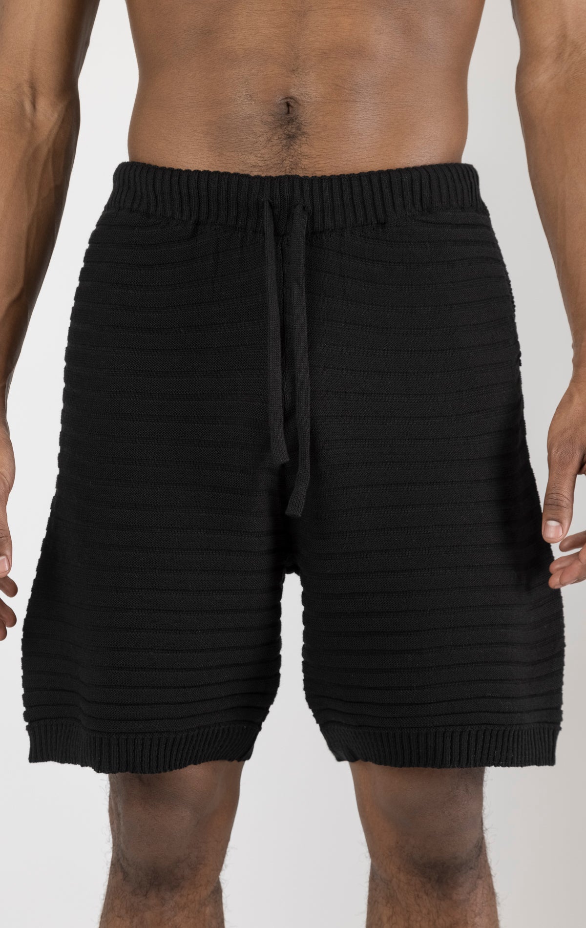 Men's black eyelet short sleeve knit top and shorts set in a variety of colors. The set is made from a soft and breathable knit fabric (50% viscose, 50% polyamide) and features a relaxed-fit top with eyelet detailing on the short sleeves and comfortable shorts with an elastic waistband.