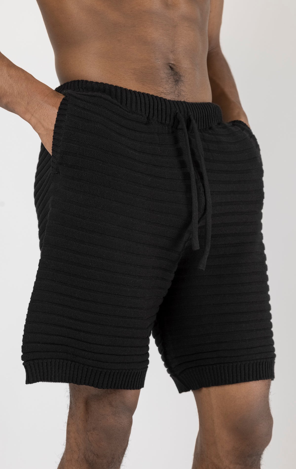 Men's black eyelet short sleeve knit top and shorts set in a variety of colors. The set is made from a soft and breathable knit fabric (50% viscose, 50% polyamide) and features a relaxed-fit top with eyelet detailing on the short sleeves and comfortable shorts with an elastic waistband.