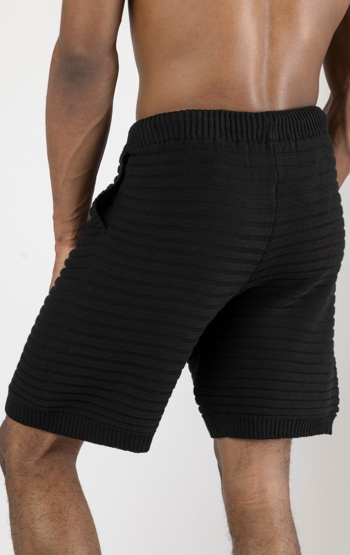 Men's black eyelet short sleeve knit top and shorts set in a variety of colors. The set is made from a soft and breathable knit fabric (50% viscose, 50% polyamide) and features a relaxed-fit top with eyelet detailing on the short sleeves and comfortable shorts with an elastic waistband.