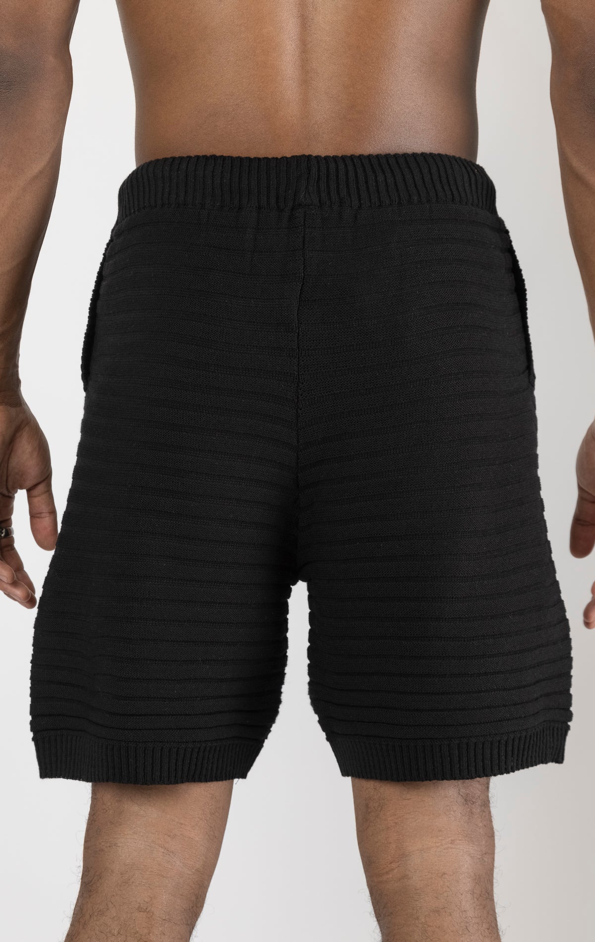 Men's black eyelet short sleeve knit top and shorts set in a variety of colors. The set is made from a soft and breathable knit fabric (50% viscose, 50% polyamide) and features a relaxed-fit top with eyelet detailing on the short sleeves and comfortable shorts with an elastic waistband.
