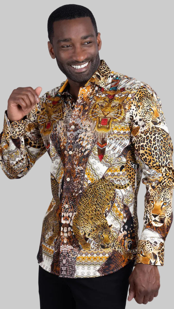 A man wearing a long-sleeve button-up shirt with an intricate, busy print featuring leopards, lions, and tribal patterns in brown, gold, black, and white, paired with black pants against a light gray background.