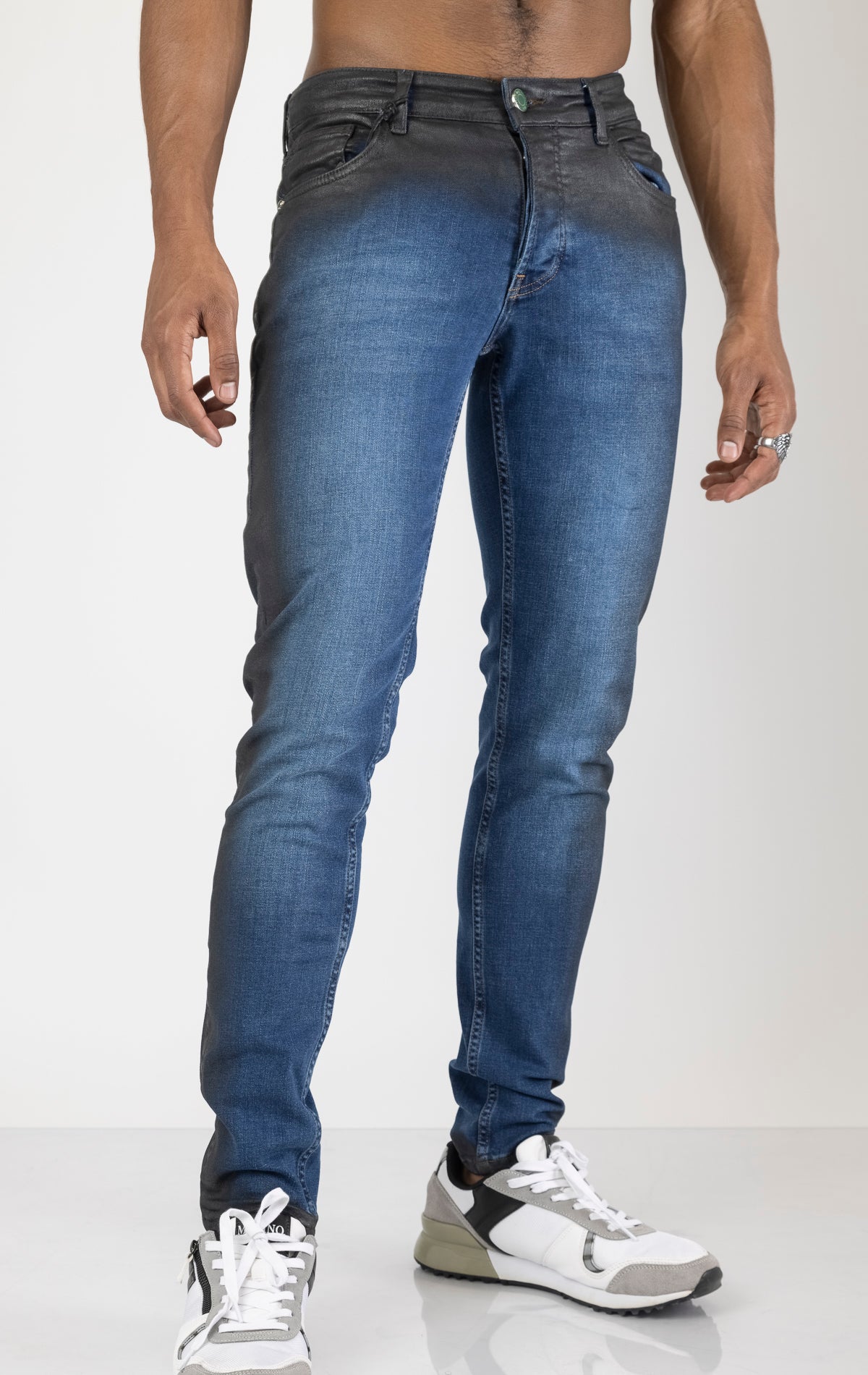 Men's side waxed tapered jeans in blue. The jeans are made from premium quality denim (98% cotton, 2% lycra) and feature a tailored fit, meticulously applied waxed detailing along the side seams, and a tapered leg.