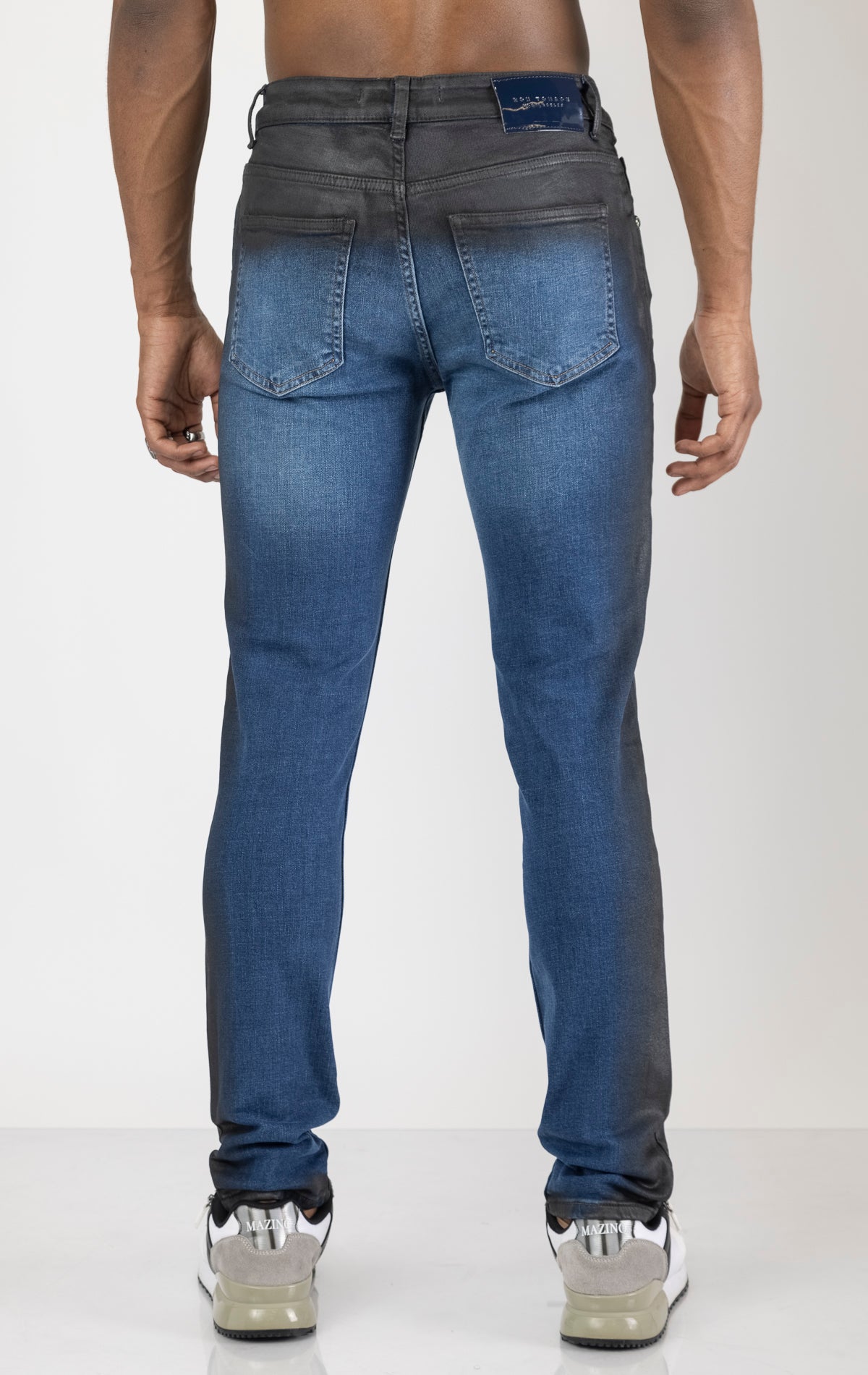 Men's side waxed tapered jeans in blue. The jeans are made from premium quality denim (98% cotton, 2% lycra) and feature a tailored fit, meticulously applied waxed detailing along the side seams, and a tapered leg.