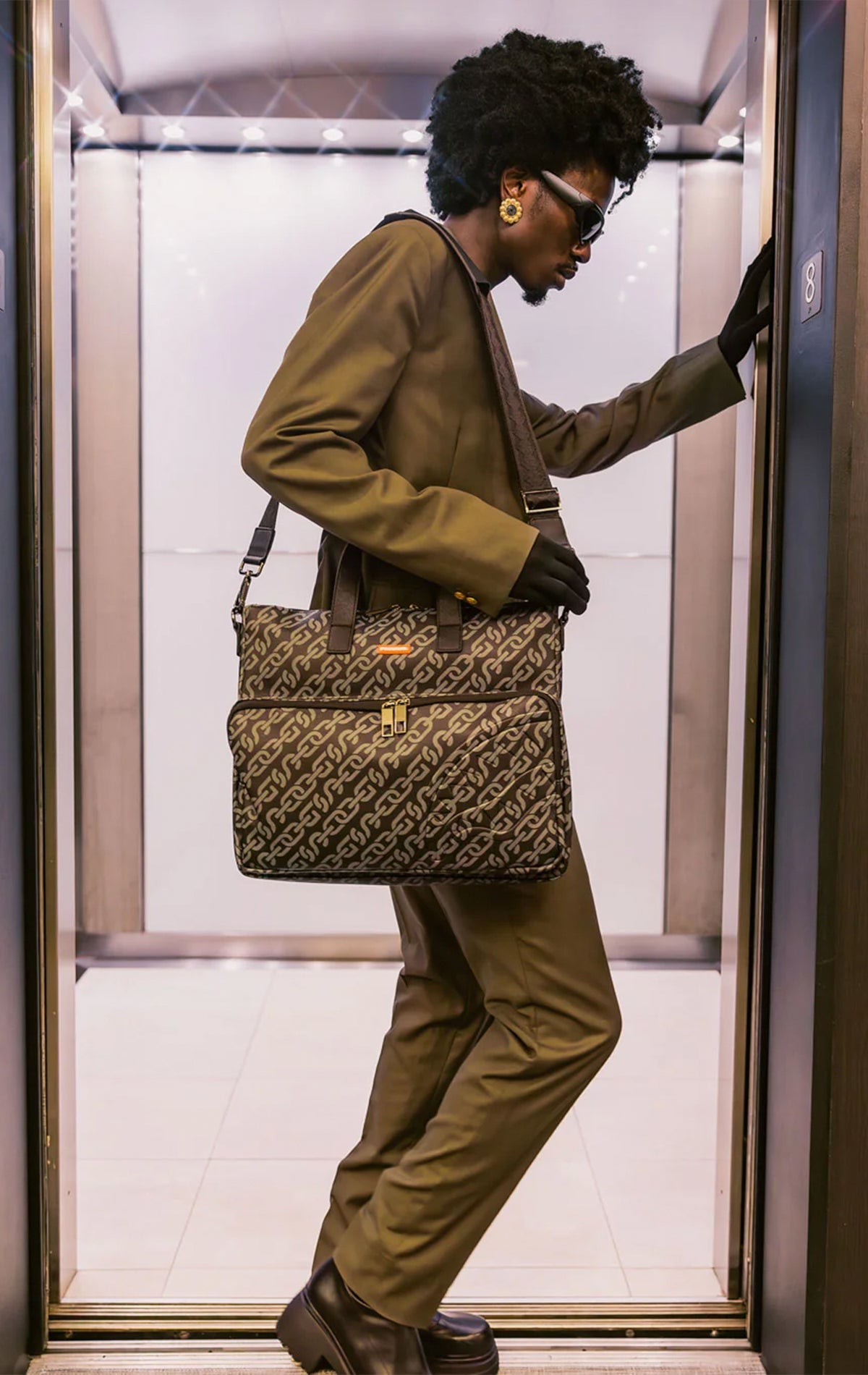 Sprayground, Magnetic Pulse Travel Bag, vegan leather, travel bag, magnetic pulse print, sunglasses compartment, padded back panel, adjustable straps, spacious, stylish, functional.