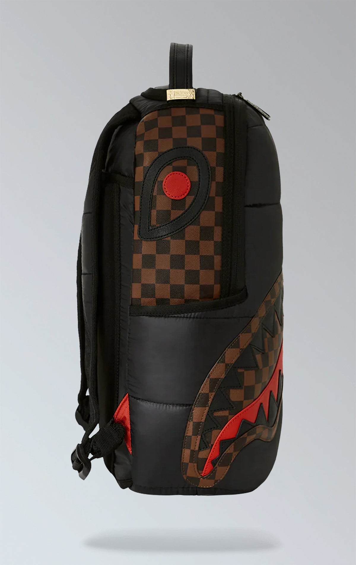 Black Sprayground backpack with a horizontal quilted puffer jacket-inspired design. Features multiple compartments including a separate velour laptop compartment, side pockets, and a hidden zippered pocket.  Equipped with ergonomic mesh back padding, adjustable straps, and a sliding back sleeve for attaching to carry-on luggage. Made from durable 100% polyester techy fabric with horizontal quilting.