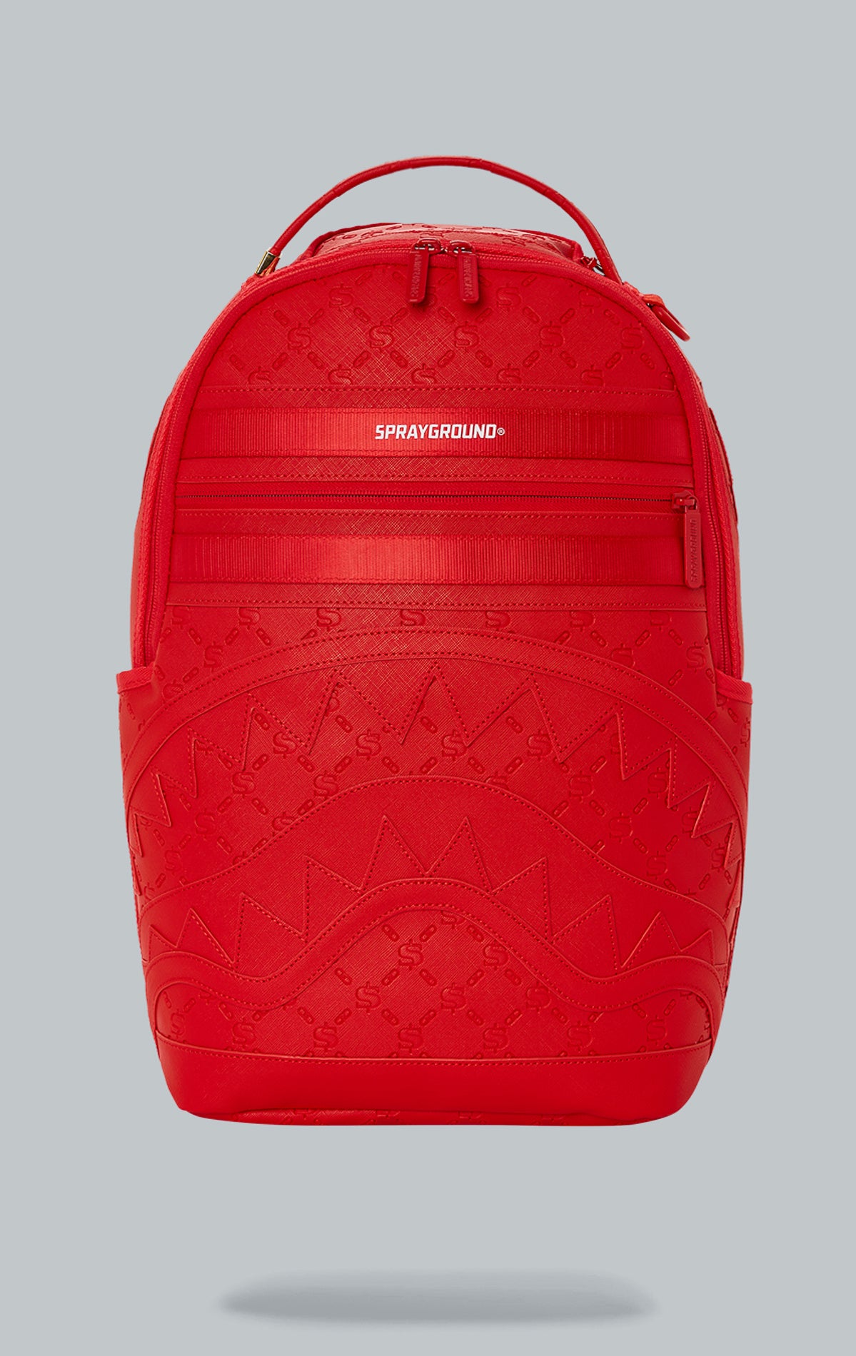 Sprayground Deniro Red Backpack. The backpack is made from durable water-resistant faux leather (100%) and features a red exterior. It includes a front zipper pocket, side pockets, a zippered stash pocket, a separate velour sunglass compartment, ergonomic mesh back padding, adjustable straps, gold zippers with metal hardware, and a metal 