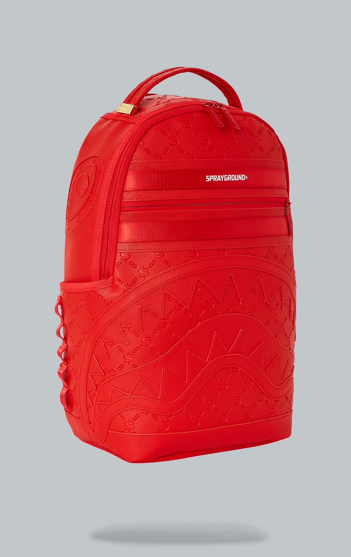 Sprayground Deniro Red Backpack. The backpack is made from durable water-resistant faux leather (100%) and features a red exterior. It includes a front zipper pocket, side pockets, a zippered stash pocket, a separate velour sunglass compartment, ergonomic mesh back padding, adjustable straps, gold zippers with metal hardware, and a metal 