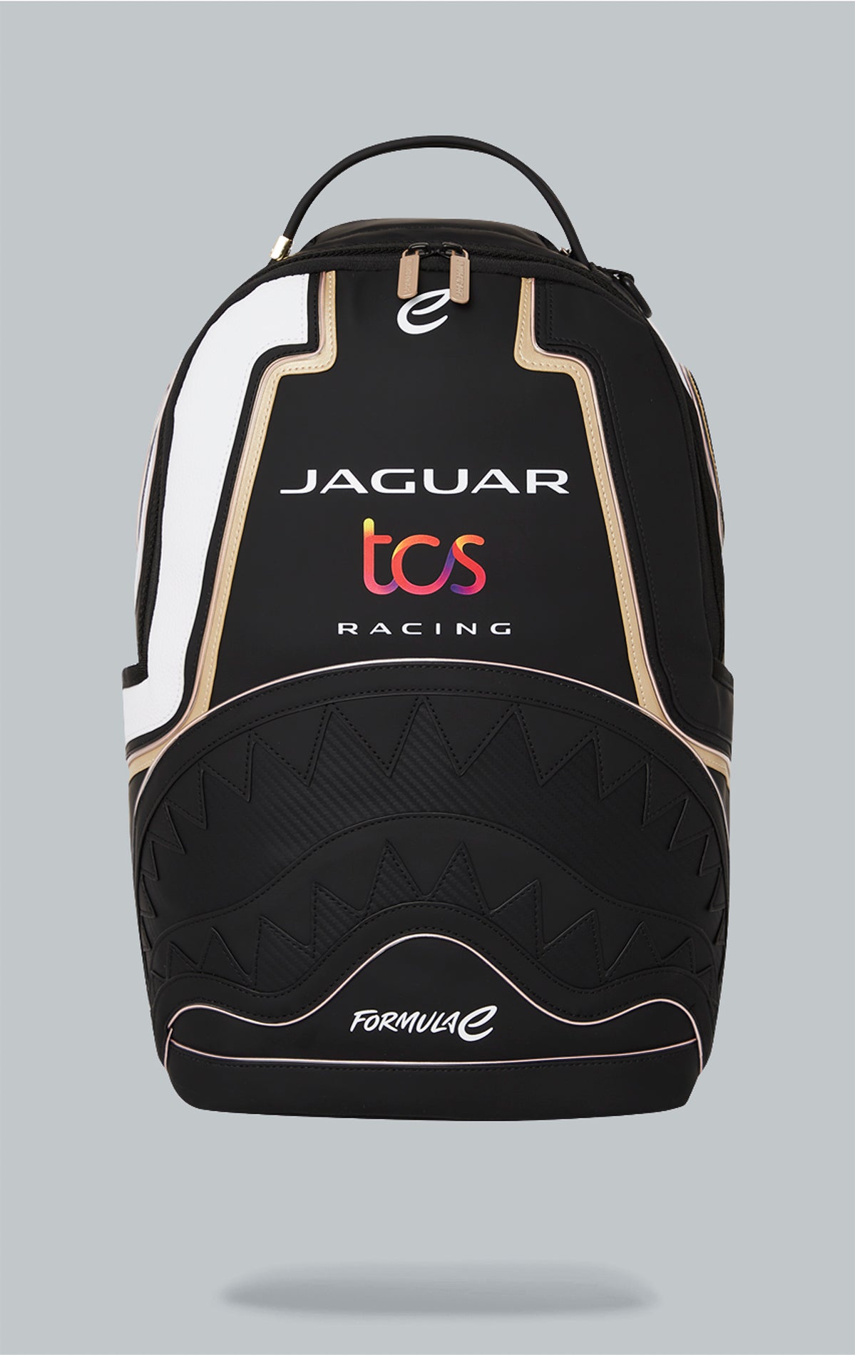 Sprayground x Formula E Jaguar backpack with built-in LED lights. Black water-resistant PVC backpack with Formula E Jaguar design. Includes laptop compartment, organizer pocket, and USB cable for charging. Note: Lithium battery inside, check with airline before travel.
