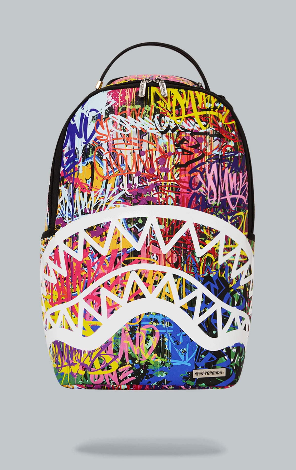 Sprayground Lower East Side Shark Backpack. The backpack is made from durable water-resistant faux leather (100%) and features a black exterior with a shark graphic. It includes a front zipper pocket, side pockets, a zippered stash pocket, a separate velour sunglass compartment, ergonomic mesh back padding, adjustable straps, gold zippers with metal hardware, and a metal 