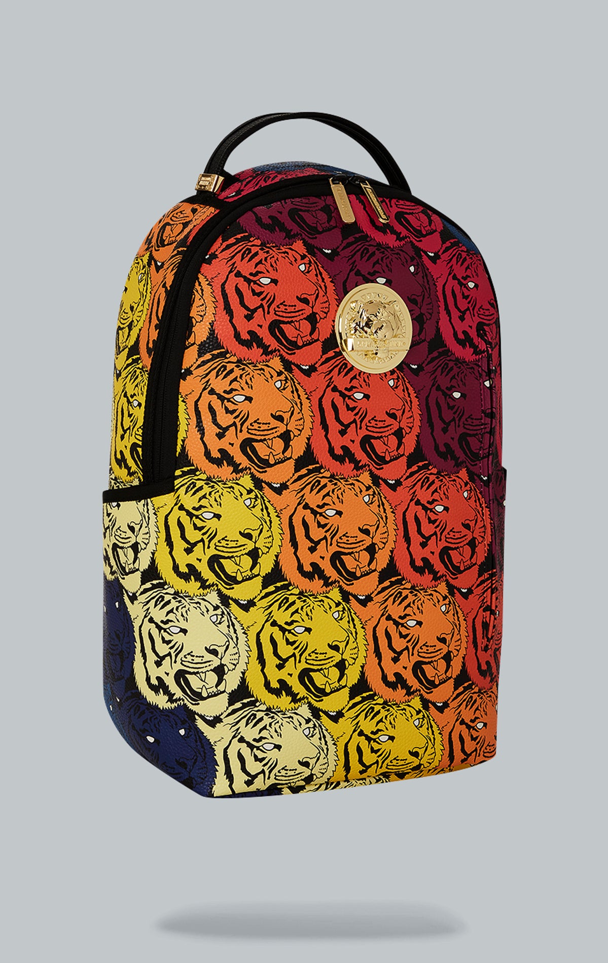 Sprayground Tigers on My Mind Backpack. The backpack is made from durable faux leather (100% PVC) and features a gold metal plated tiger emblem, a front zipper pocket, side pockets, a zippered stash pocket, a separate velour sunglass compartment, ergonomic mesh back padding, adjustable straps, and a slide through back sleeve that connects to carry-on luggage. The interior includes a separate velour laptop compartment and a mesh organizer pocket.  pen_spark     tune  share   more_vert