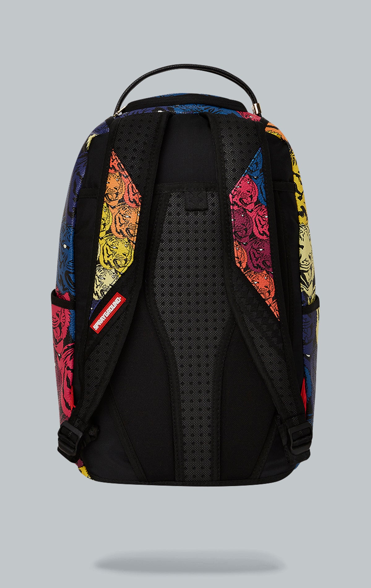 Sprayground Tigers on My Mind Backpack. The backpack is made from durable faux leather (100% PVC) and features a gold metal plated tiger emblem, a front zipper pocket, side pockets, a zippered stash pocket, a separate velour sunglass compartment, ergonomic mesh back padding, adjustable straps, and a slide through back sleeve that connects to carry-on luggage. The interior includes a separate velour laptop compartment and a mesh organizer pocket.  pen_spark     tune  share   more_vert