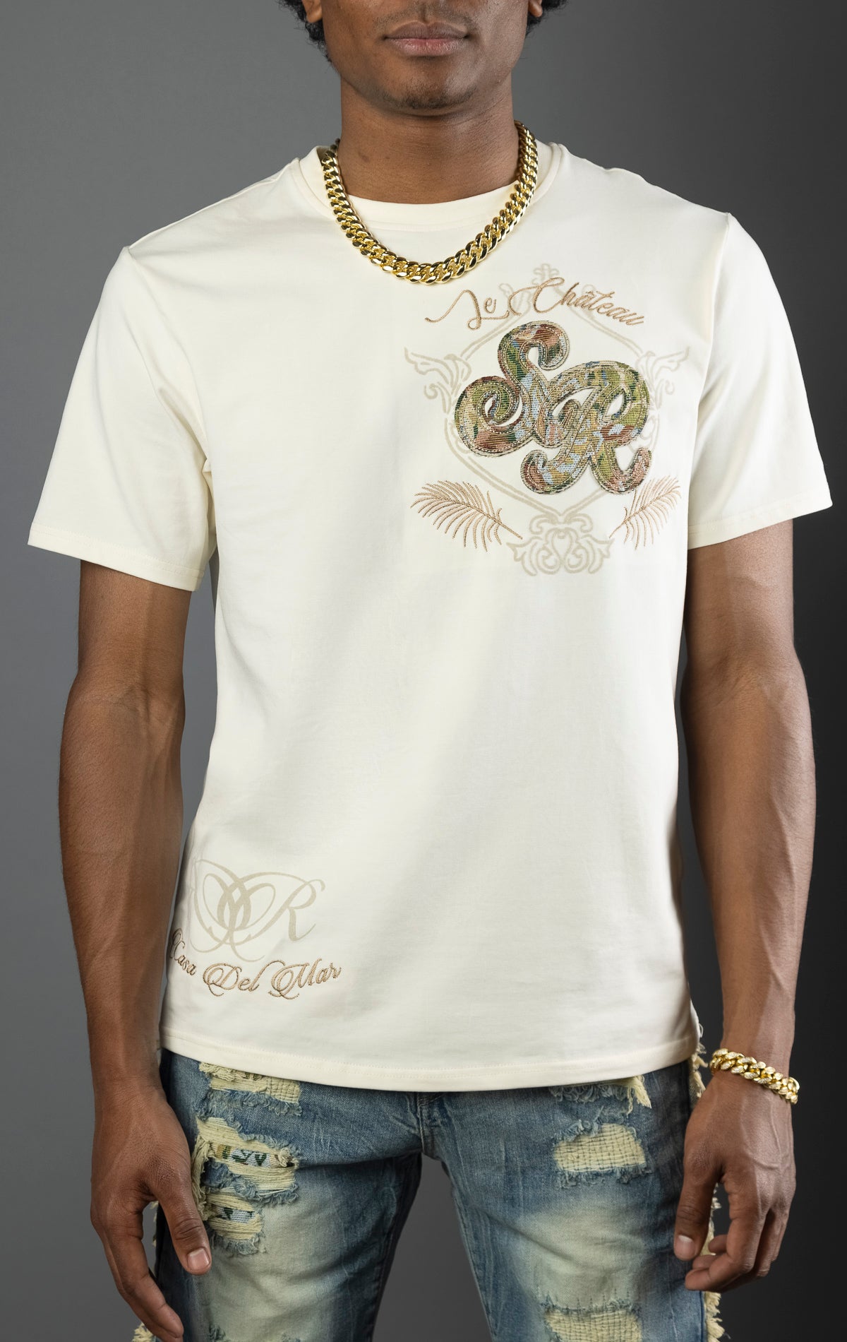 Men's t-shirt in a chalk  color with a regular fit. The shirt features a tapestry design on the front left chest and back. Made from a blend of 95% cotton and 5% spandex.