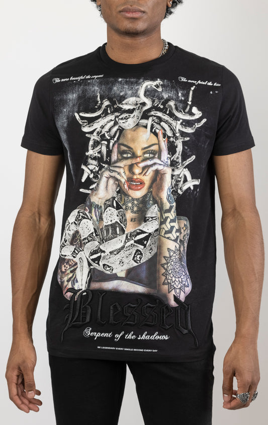 Men's regular fit t-shirt in black. The shirt features a slightly elongated sleeve, a fitted neckline, and a straight body. It has a "Serpent of the Shadows" front print with 3D embroidery. Made from 100% cotton jersey (190gsm). A "blessed" slogan is printed on the inner neck binding and a woven side seam tab with "blessed" is also included.