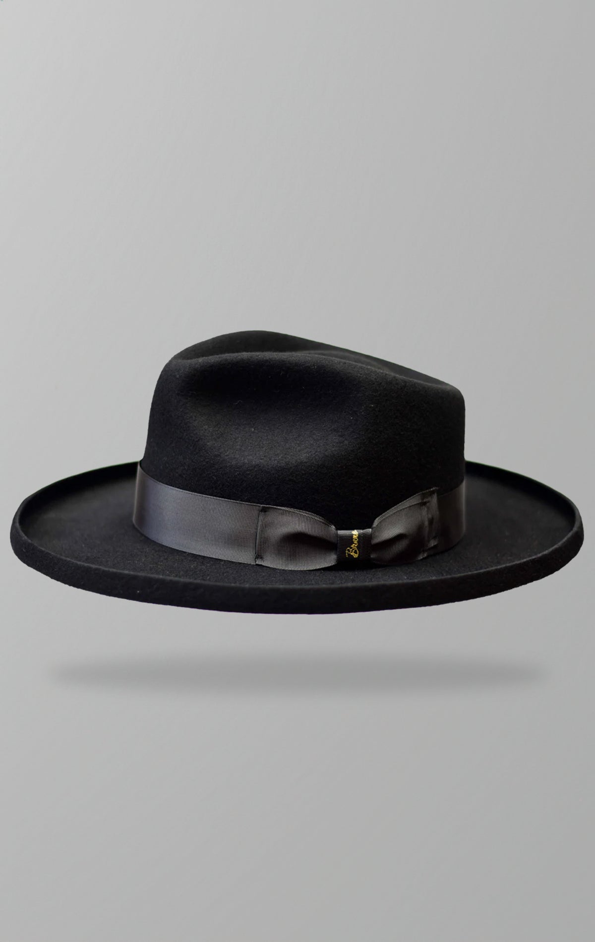 Rebel Fedora hat made from 100% Australian Wool with a 3.25-inch pencil brim, grosgrain ribbon, and a full-bodied teardrop crown.