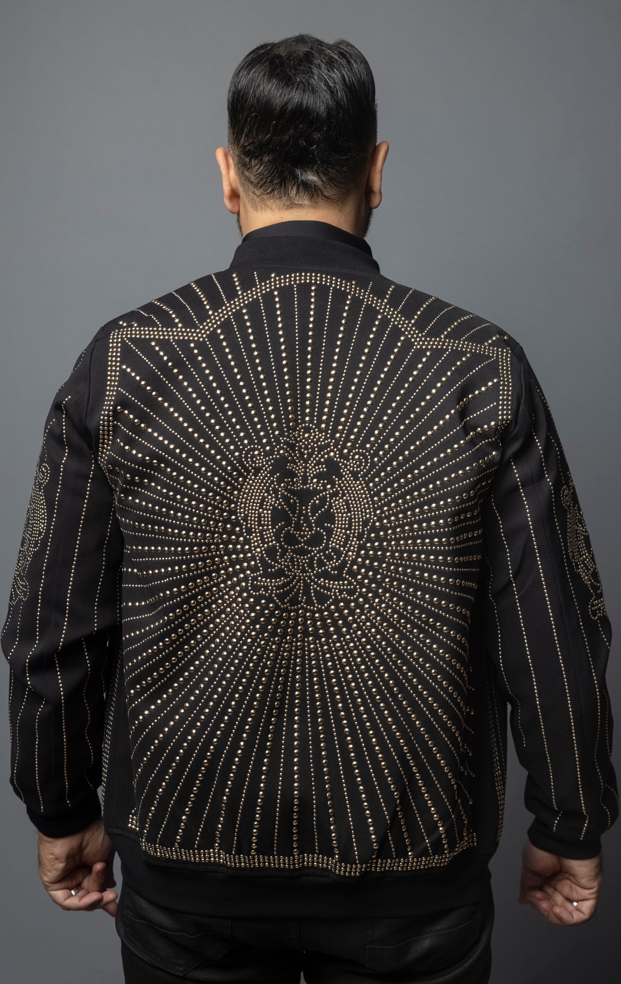 omber jacket with geometric lion studs and striped ribbed design.