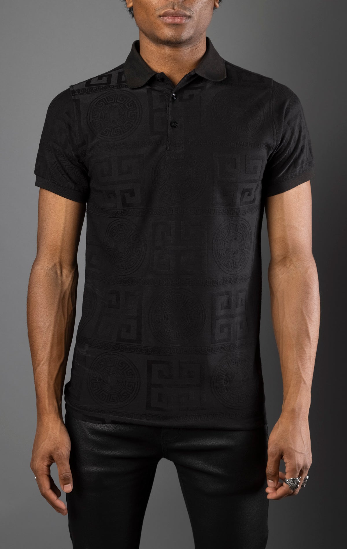 Black Men's regular-fit, short-sleeve polo shirt. The shirt features a seamless Greek pattern and a classic polo design